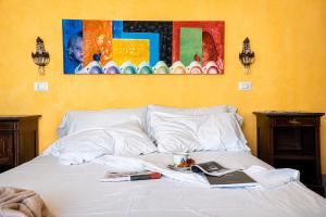 a bed with a plate of food and a book on it at Casa D'aria in Catania