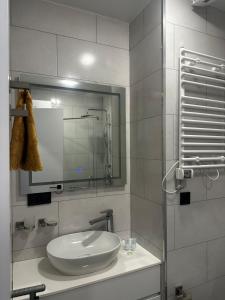 a bathroom with a sink and a mirror at Paradise Apartments Solis in Batumi +20 photos