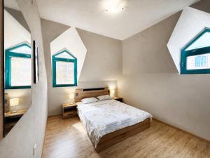a bedroom with a bed and two windows at Ravda Bay Guest House in Ravda +58 photos