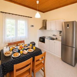 a kitchen with a table with plates of food on it at Villa Yannis 1 in Roda