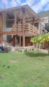 a large house with a deck and a yard at Intikilla House in Cusco +6 photos
