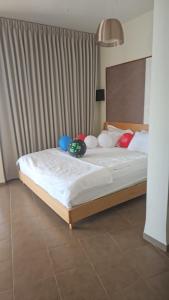 a bedroom with a bed with many pillows on it at Red and White אדום לבן in Amirim +20 photos
