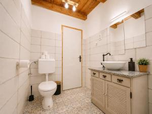 a bathroom with a toilet and a sink at Három Dió Vendégház in Nyim +17 photos