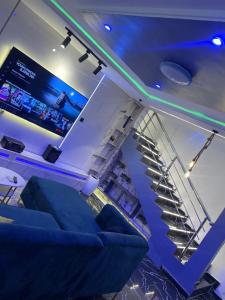 a spiral staircase in a room with blue lights at PrimeNest Apartment in Lekki