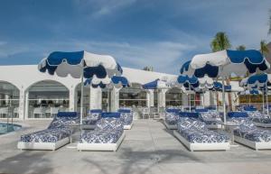 a group of blue and white chairs and umbrellas at Kalithea Horizon Blu - Adults Only in Kallithea Rhodes +45 photos