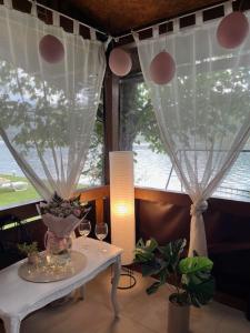 a room with a table with two glasses and a window at Vikendica Vilcek in Mali Zvornik