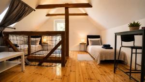 a bedroom with two bunk beds in a attic at Három Dió Vendégház in Nyim