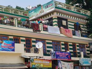 a building with clothes hanging on the balconies of it at Vinod Tourist Lodge in Gupta Kāshi