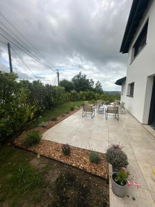a patio with chairs and a table in a yard at Villa ALDAKETA in Urrugne