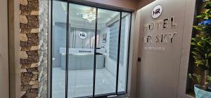 a hotel entrance with a glass revolving door at Hotel HR Sky in Ahmedabad