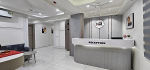a waiting room with a reception desk in a building at Hotel HR Sky in Ahmedabad