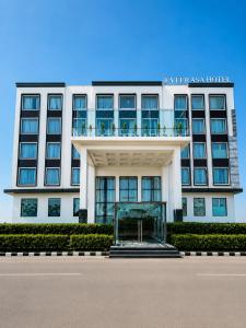 a white building with a balcony on top of it at Veerasa Hotel in Hanumāngarh