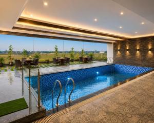 a swimming pool in the middle of a house at Veerasa Hotel in Hanumāngarh