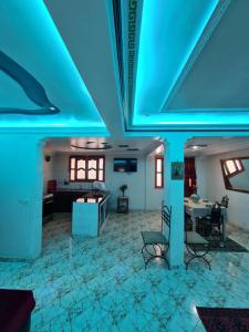 a living room with a blue light on the ceiling at Banana Aourir in Aourir