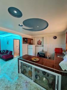 a kitchen with a fish tank in a living room at Banana Aourir in Aourir