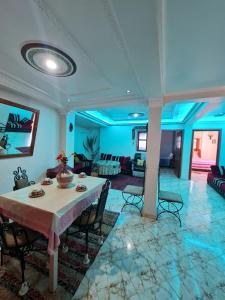 a dining room with a table and a living room at Banana Aourir in Aourir +17 photos