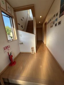 a room with a staircase and a stair case at 小さなペンション Branchee in Kushimoto +35 photos
