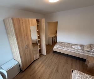 a small room with a bed and a closet at VP sobe in Ilirska Bistrica +15 photos