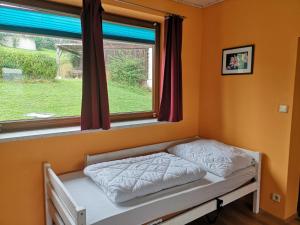 a bed in a room with a window at Apartment Rappitsch in Sankt Marein bei Knittelfeld