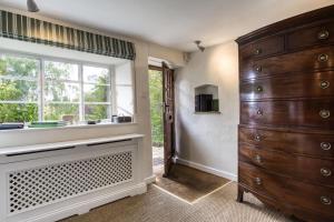 a kitchen with a large dresser and a window at Top Cottage, Oddington in Adlestrop +40 photos