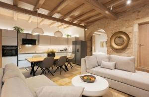 a living room with a couch and a table at Arco Segreto Apartment, Old Town in Corfu +16 photos