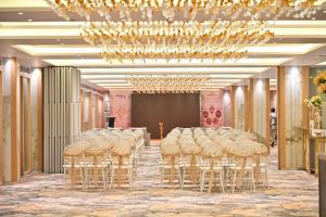 a room with a row of stools in a room at Pride Elite Himmatnagar in Sonāsan