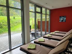 a room with a row of beds against a wall at Hotel Bergkristall in Wildalpen