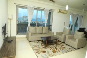a living room with two couches and a table at Shastik Residency in Oragadam