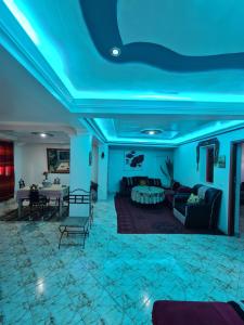 a living room with blue lights on the ceiling at Banana Aourir in Aourir