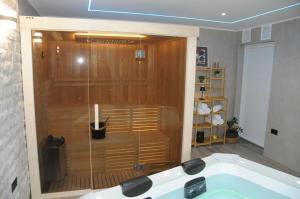 a bathroom with a shower with a bath tub at Villa Lapis in Mostar