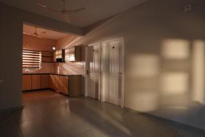 a room with a kitchen with a door and a counter at Blue Pearl Residency in Trivandrum