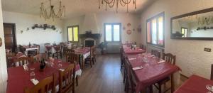 a restaurant with tables and chairs with red tablecloths at Ca Vecia in Gargnano