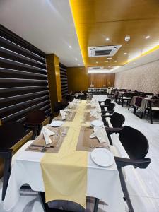 a long dining room with a long table and chairs at Crystal Heritage Inn in Dhaka