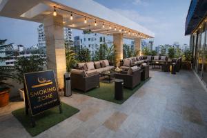 a large outdoor patio with couches and a sign at Crystal Heritage Inn in Dhaka