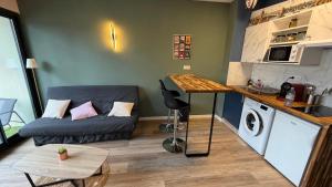 a small living room with a couch and a table at Loft Tolosa - Clim & Parking Privé Toulouse Nord in Rouffiac-Tolosan +42 photos