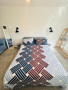 a bedroom with a bed with a colorful bedspread at Ansari House in Dummer