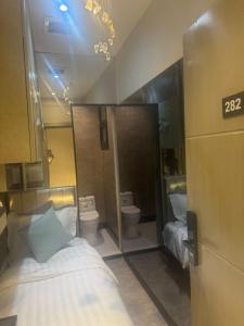a bedroom with two toilets and a bed in a room at Transit Room in Riyadh