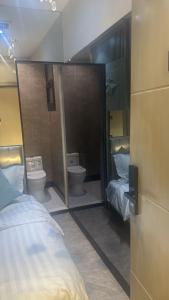a bedroom with two beds and two toilets at Transit Room in Riyadh