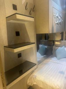 a bedroom with a bed and shelves in it at Transit Room in Riyadh +11 photos