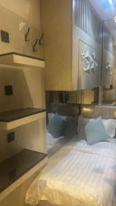 a bedroom with a large bed with white sheets at Transit Room in Riyadh