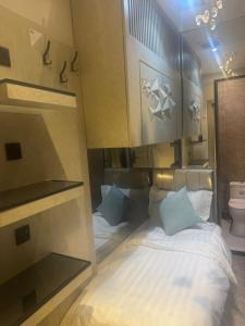 a small bedroom with a bed and a toilet at Transit Room in Riyadh