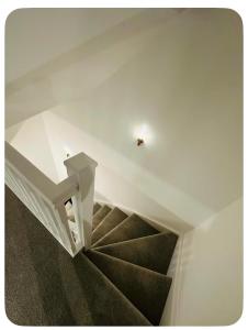 a staircase in a house with a white ceiling at Ansari House in Dummer +3 photos
