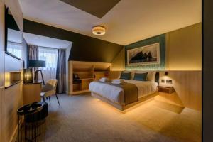 a bedroom with a bed and a desk and a chair at The Gable, Dingle in Dingle