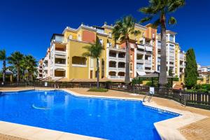 a swimming pool in front of a building at Playa Grande SOLMARES in Isla del Moral