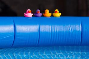 a group of rubber ducks sitting on top of a pool at La Maison Bornat in Versaugues