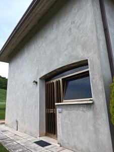 a gray building with a door and a window at Carpineti Republic in Monterone