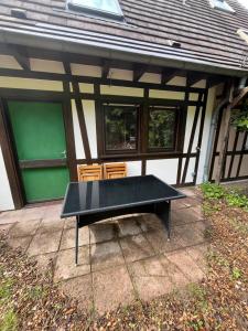 a ping pong table in front of a house at Le chalet de Pfaffenbronn in Lembach