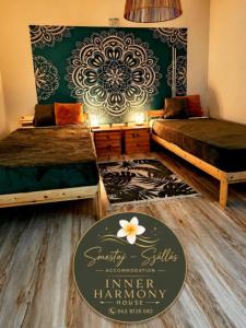 a room with two beds and a sign that reads linen harmony house at Inner Harmony Garden in Kanjiža