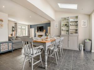 a kitchen and dining room with a table and chairs at Greenrush Cottage in Blakeney