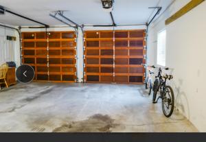 a garage with two bikes parked in front of doors at Forest house 4 bedrooms in Surrey